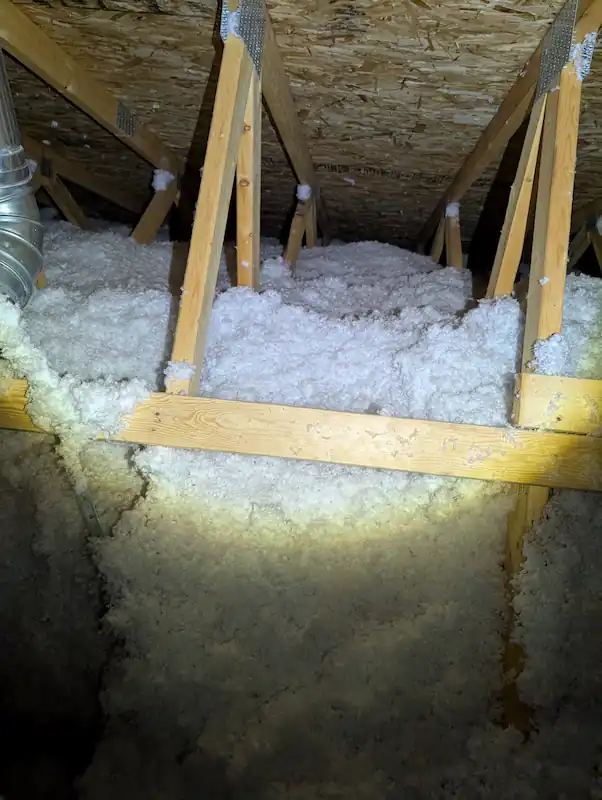 Blown-in attic insulation inspection during seasonal maintenance visit in Traverse City, MI