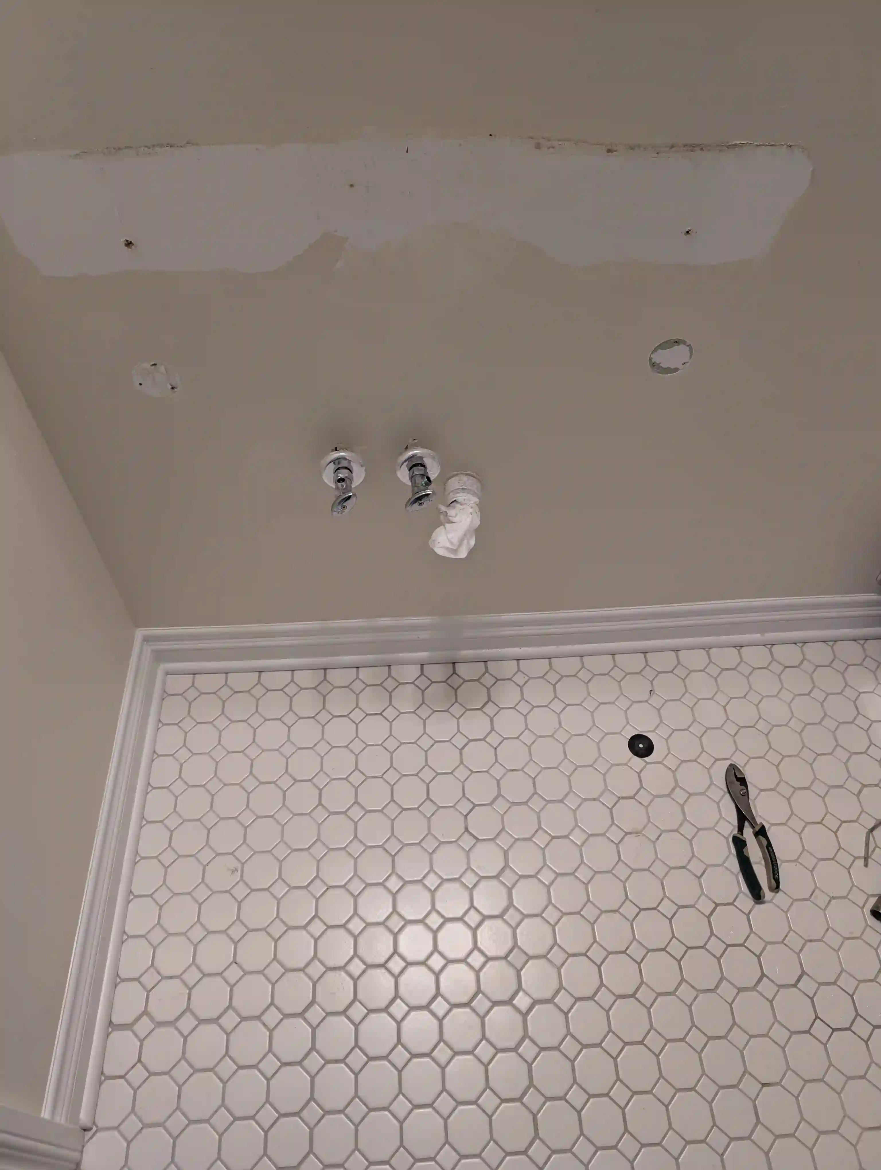 Wall exposed after console sink removal showing supply valves — Cedar, MI