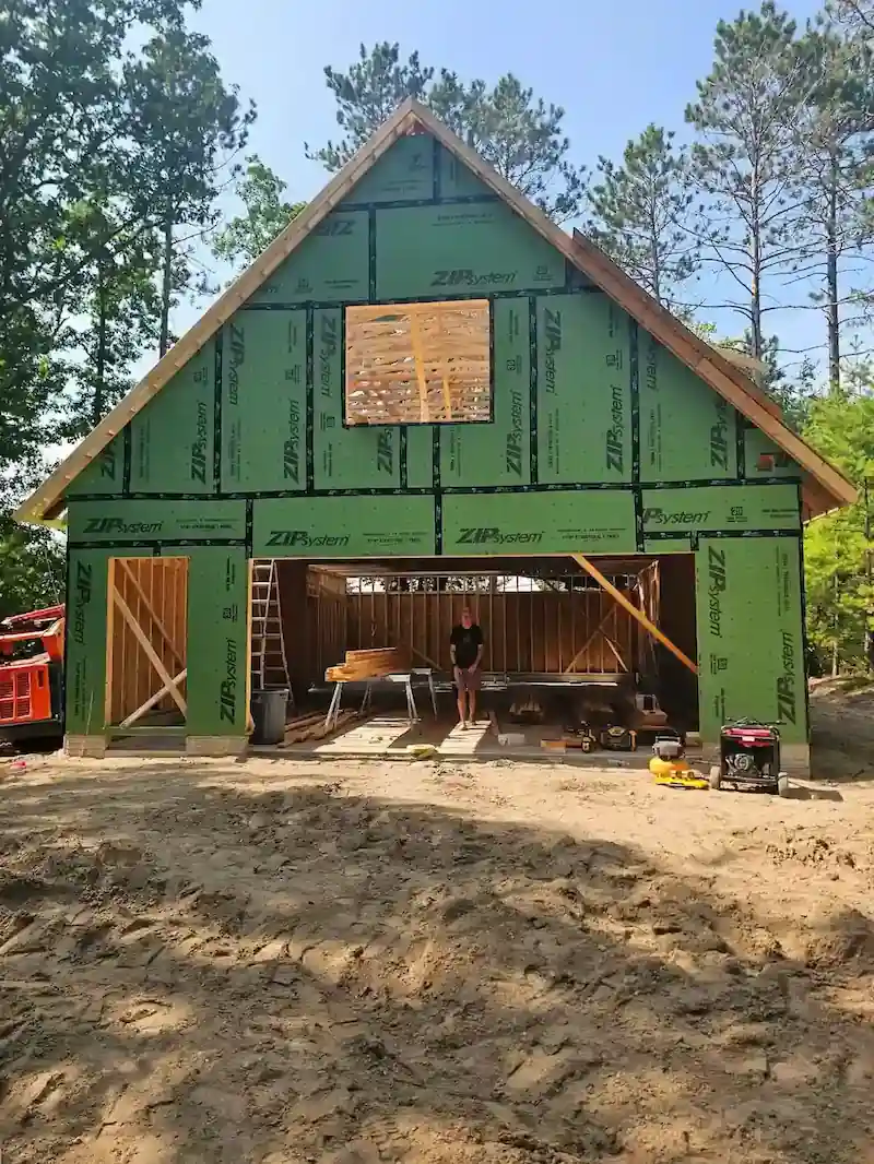 Licensed builder reviewing construction plans during project consulting in Northern Michigan