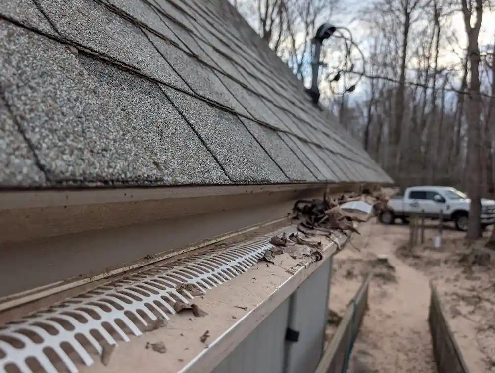 Gutter cleaning and debris removal at a Benzie County lakefront property